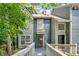 Charming townhome with wood siding and a walkway leading to a glass front door at 1438 N Crossing Ne Dr, Atlanta, GA 30329
