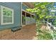 Exterior view from wooded area showing covered patio beneath the building with fenced in area at 1438 N Crossing Ne Dr, Atlanta, GA 30329