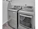 Laundry room with new-looking washer and dryer units and wire shelving at 1438 N Crossing Ne Dr, Atlanta, GA 30329