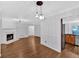 Hardwood floored living room featuring a fireplace and a decorative chandelier at 1438 N Crossing Ne Dr, Atlanta, GA 30329