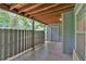 A covered patio with tile floor, a fence, and a door to storage at 1438 N Crossing Ne Dr, Atlanta, GA 30329