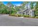 Street view of townhome exteriors surrounded by landscaping and trees at 1438 N Crossing Ne Dr, Atlanta, GA 30329