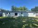 Spacious, private backyard with a freshly painted exterior, sliding glass doors and an expansive green lawn at 2678 Stardust Trl, Decatur, GA 30034