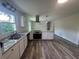 Bright, open kitchen featuring white cabinets, granite countertops, stainless steel appliances, and hardwood floors at 2678 Stardust Trl, Decatur, GA 30034