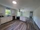 Well-lit kitchen with white cabinets, granite countertops, stainless steel appliances, and modern hardwood floors at 2678 Stardust Trl, Decatur, GA 30034
