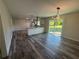 Open-concept living room featuring wood floors, modern lighting, and sliding glass doors to the backyard at 2678 Stardust Trl, Decatur, GA 30034