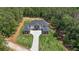 Aerial view of a modern home with a manicured lawn and a welcoming driveway at 2843 N North Bogan Rd, Buford, GA 30519