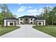 Beautiful home exterior with attached two-car garages, long driveway, and well-manicured lawn at 2843 N North Bogan Rd, Buford, GA 30519