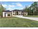 Well-manicured lawn leads up to this stunning modern home with unique architecture and design at 2843 N North Bogan Rd, Buford, GA 30519