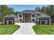 Stunning two-story home featuring a symmetrical design and large front yard with a long private driveway at 2843 N North Bogan Rd, Buford, GA 30519