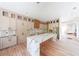 Spacious kitchen with custom cabinets, a center island with marble countertop, and hardwood floors at 2843 N North Bogan Rd, Buford, GA 30519