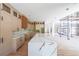 Spacious kitchen with custom cabinets, a large island with marble countertop, and hardwood floors at 2843 N North Bogan Rd, Buford, GA 30519