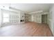 Expansive main bedroom featuring a marble fireplace, hardwood floors, a tray ceiling, and access to ensuite at 2843 N North Bogan Rd, Buford, GA 30519