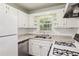 Bright kitchen showcases granite countertops, white subway tile backsplash and stainless steel dishwasher and stove at 3314 Glenco Dr, Decatur, GA 30032