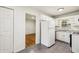 Efficient kitchen features white cabinets, stainless sink, and adjacent breakfast bar with views into the living area at 3314 Glenco Dr, Decatur, GA 30032