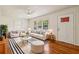Bright living room featuring hardwood floors, neutral paint, a ceiling fan, and comfortable seating arrangement at 3314 Glenco Dr, Decatur, GA 30032