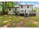 Spacious backyard with a back view of a two-story home, featuring multiple decks and stairways at 4723 N Springs Nw Rd, Kennesaw, GA 30144