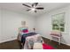 Charming bedroom with bright accents, hardwood floors, and a window with treetop views at 4723 N Springs Nw Rd, Kennesaw, GA 30144