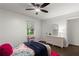 Colorful bedroom with wicker furniture, hardwood floors, and a window at 4723 N Springs Nw Rd, Kennesaw, GA 30144