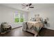 Bedroom with wood-look flooring and natural light from the windows at 4723 N Springs Nw Rd, Kennesaw, GA 30144