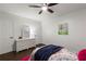 Bright bedroom featuring a white dresser, hardwood floors, and colorful decor at 4723 N Springs Nw Rd, Kennesaw, GA 30144