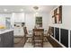 Cozy dining area next to kitchen features modern lighting, stylish art, and a round glass table at 4723 N Springs Nw Rd, Kennesaw, GA 30144