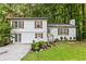 Charming home with white siding, brick accents, manicured lawn, and beautiful landscaping at 4723 N Springs Nw Rd, Kennesaw, GA 30144