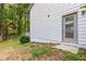 Side view of a white home featuring a treehouse in the back and an access door at 4723 N Springs Nw Rd, Kennesaw, GA 30144