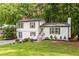 Charming home with white siding, brick accents, manicured lawn, and beautiful landscaping at 4723 N Springs Nw Rd, Kennesaw, GA 30144