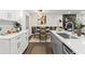 Modern kitchen featuring white cabinets, quartz countertops, and a dining area with stylish decor at 4723 N Springs Nw Rd, Kennesaw, GA 30144