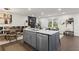 Stylish kitchen with white countertops, gray island, stainless steel appliances, and modern lighting at 4723 N Springs Nw Rd, Kennesaw, GA 30144