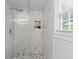 Large walk-in shower features floor-to-ceiling marble-look tile at 4723 N Springs Nw Rd, Kennesaw, GA 30144