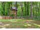 Backyard with a custom built treehouse featuring a wood frame and a metal roof at 4723 N Springs Nw Rd, Kennesaw, GA 30144