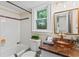 Stylish bathroom with a vessel sink, patterned countertop, and tiled bathtub at 3441 Sherrod Sw Dr, Marietta, GA 30060