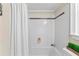 Cozy bathtub with white tiles and accent stripe at 3441 Sherrod Sw Dr, Marietta, GA 30060