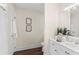 Bright bathroom featuring a white vanity with chrome hardware and framed artwork at 3441 Sherrod Sw Dr, Marietta, GA 30060