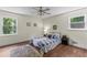 Comfortable bedroom with hardwood floors, a ceiling fan, and natural light from windows at 3441 Sherrod Sw Dr, Marietta, GA 30060