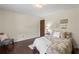 Comfortable bedroom with rich hardwood floors, love decor, and chair for relaxing at 3441 Sherrod Sw Dr, Marietta, GA 30060