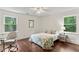 Bright bedroom featuring two windows, work space, and hardwood floors at 3441 Sherrod Sw Dr, Marietta, GA 30060