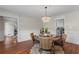 Bright dining room with hardwood floors, wainscoting, a chandelier, and a view into the kitchen at 3441 Sherrod Sw Dr, Marietta, GA 30060