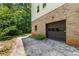 View of a side of a two-story home with brick exterior and a garage door at 3441 Sherrod Sw Dr, Marietta, GA 30060
