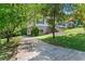 Two-story home with brick and siding exterior, surrounded by mature trees and a driveway at 3441 Sherrod Sw Dr, Marietta, GA 30060