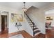 Elegant foyer featuring hardwood floors, wainscoting, a chandelier, and a staircase with dark wood treads at 3441 Sherrod Sw Dr, Marietta, GA 30060