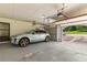 Attached garage with a gray painted floor and space for parking, plus an automatic door opener at 3441 Sherrod Sw Dr, Marietta, GA 30060
