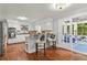 Updated kitchen with white cabinets, stainless appliances, granite counters, and sunroom access at 3441 Sherrod Sw Dr, Marietta, GA 30060