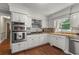 Bright kitchen features white cabinets, granite counters, stainless appliances, and hardwood floors at 3441 Sherrod Sw Dr, Marietta, GA 30060