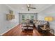 Comfortable living room featuring a sectional sofa, hardwood floors, and natural light at 3441 Sherrod Sw Dr, Marietta, GA 30060