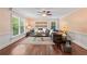 Cozy living room with hardwood floors, wainscoting, ceiling fan, and large windows providing natural light at 3441 Sherrod Sw Dr, Marietta, GA 30060