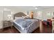 This main bedroom features hardwood floors, a tufted headboard and great lighting at 3441 Sherrod Sw Dr, Marietta, GA 30060