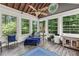 Bright sunroom with ample windows, ceiling fan, and cozy seating area overlooking the lush yard at 3441 Sherrod Sw Dr, Marietta, GA 30060